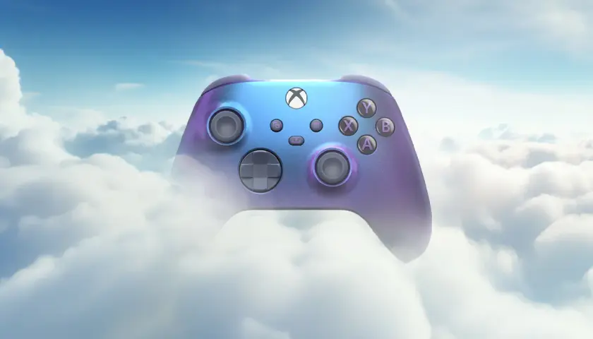 Fioletowo-niebieski kontroler Xbox unosi się wśród puszystych chmur, symbolizując granie w chmurze.