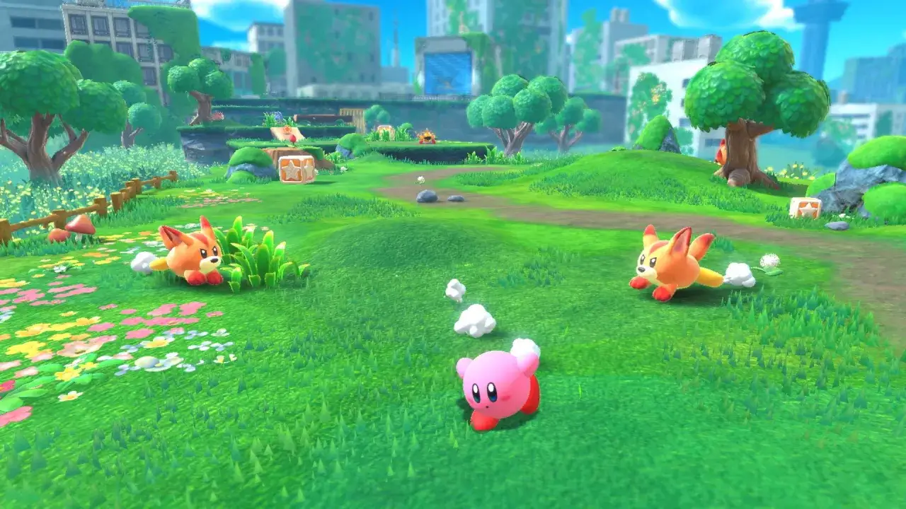 Kirby i jego przyjaciele wesoło biegają po zielonej łące, wśród kwiatów i drzew, w tle widać zrujnowane miasto.